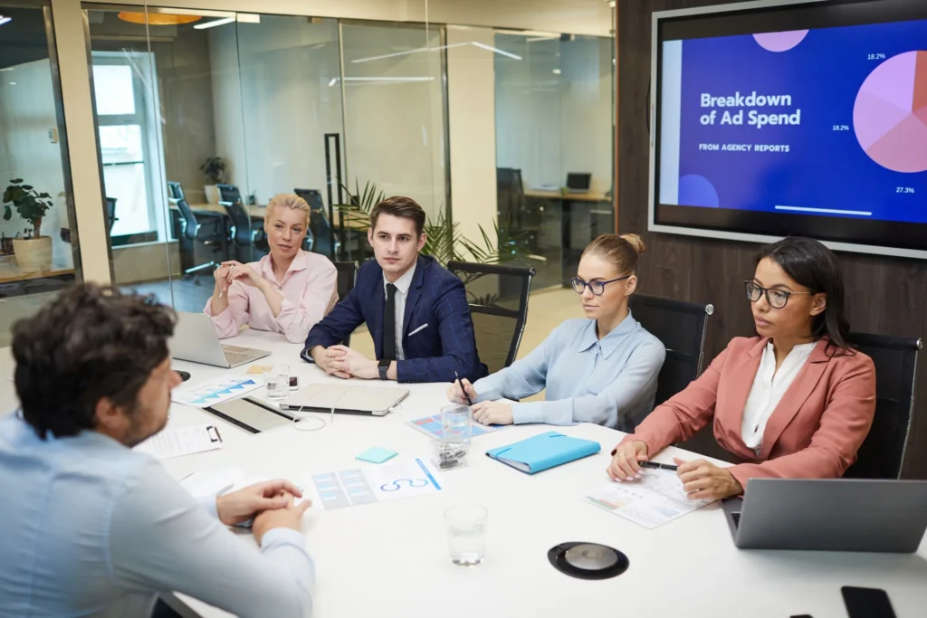 Marketing team discussing advertising performance and ad spend during a business meeting.