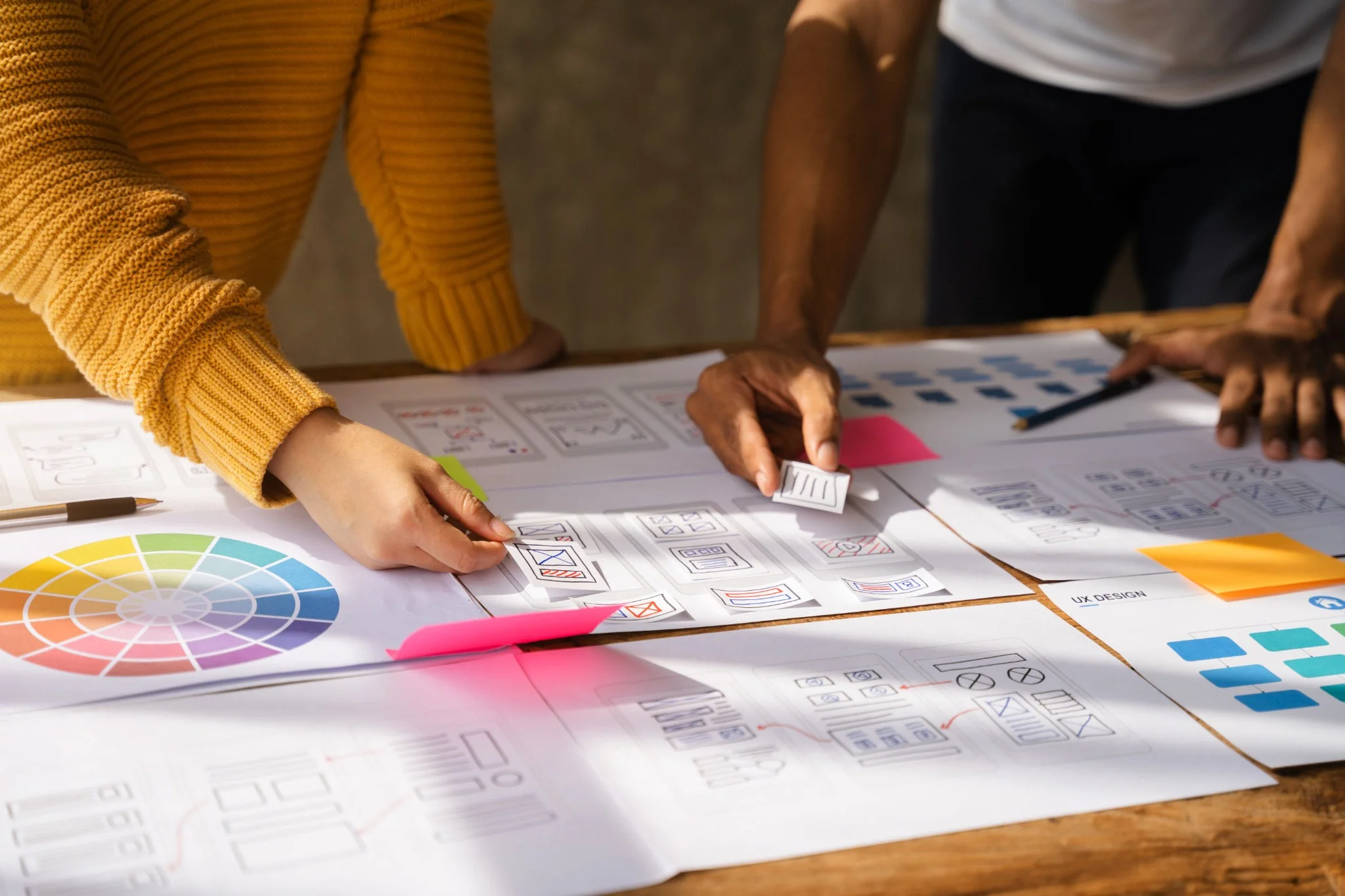 Design team reviewing website wireframes and UX color concepts.